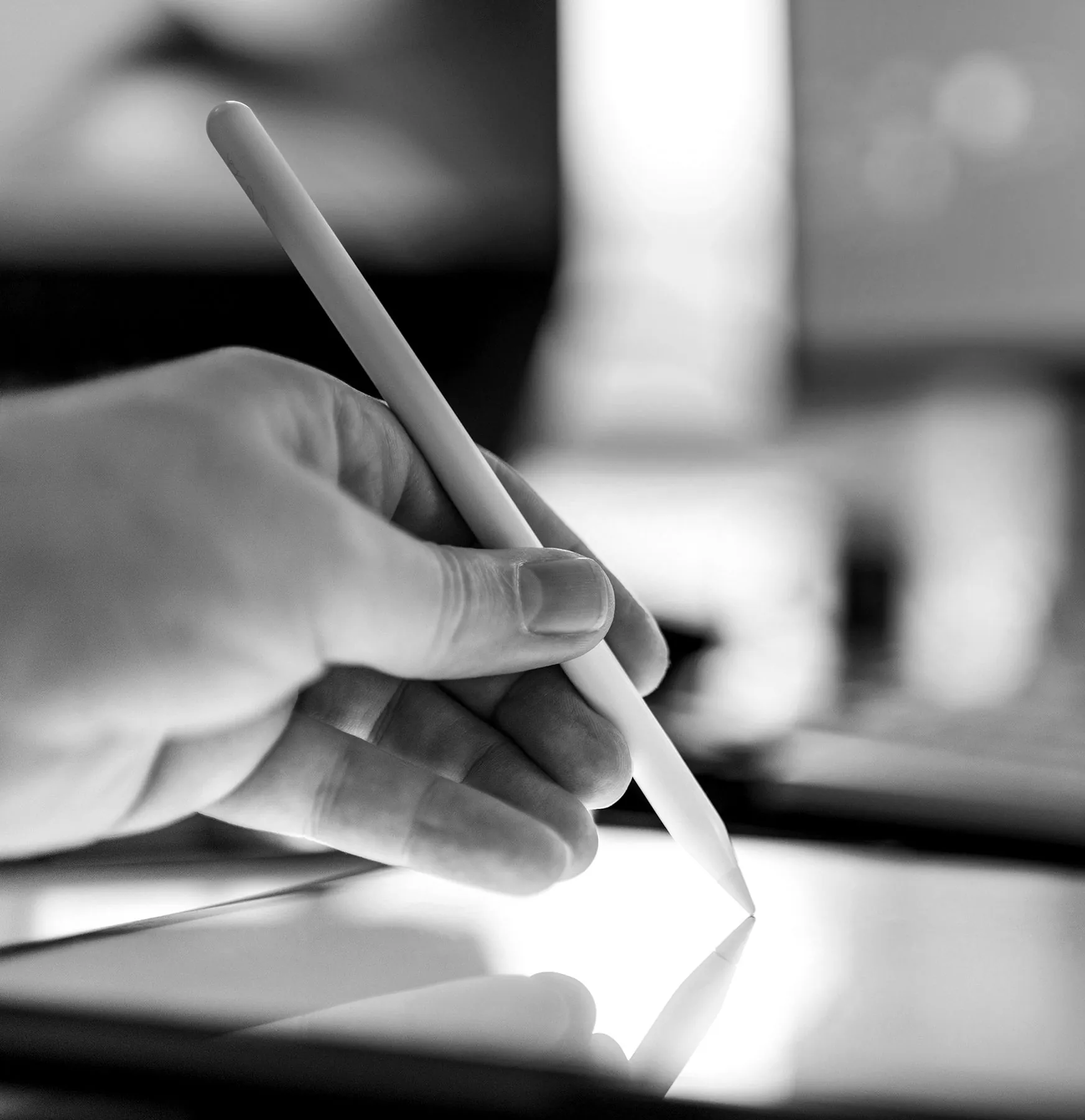 A hand drawing on a tablet with a stylus