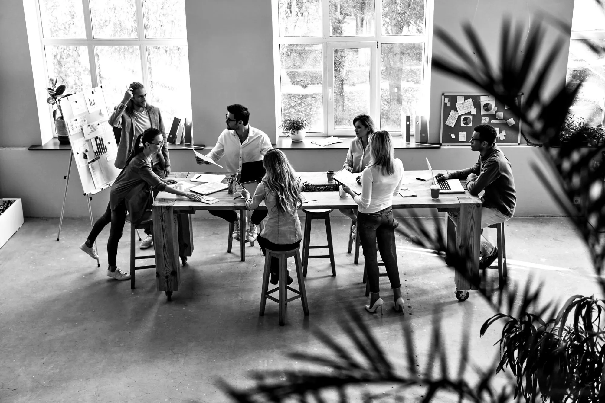 A team working around a long table, seen from above