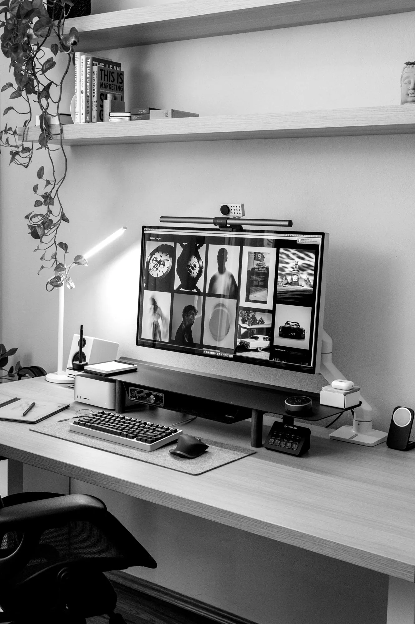 A tidy designer desk with a monitor full of visual references