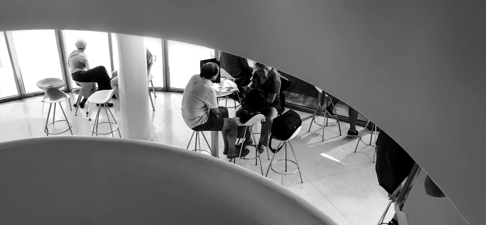 Looking down a spiral gallery onto people meeting below